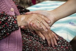 Holding elderly ladies hand